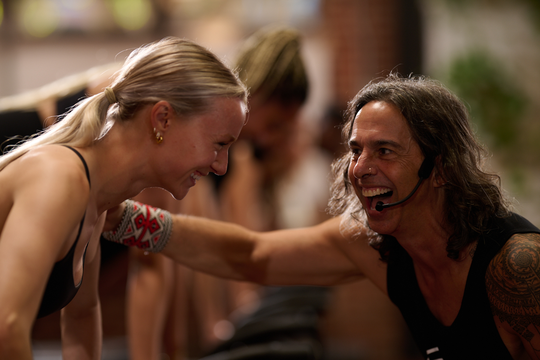 Dean laughing face-to-face with a client mid-class