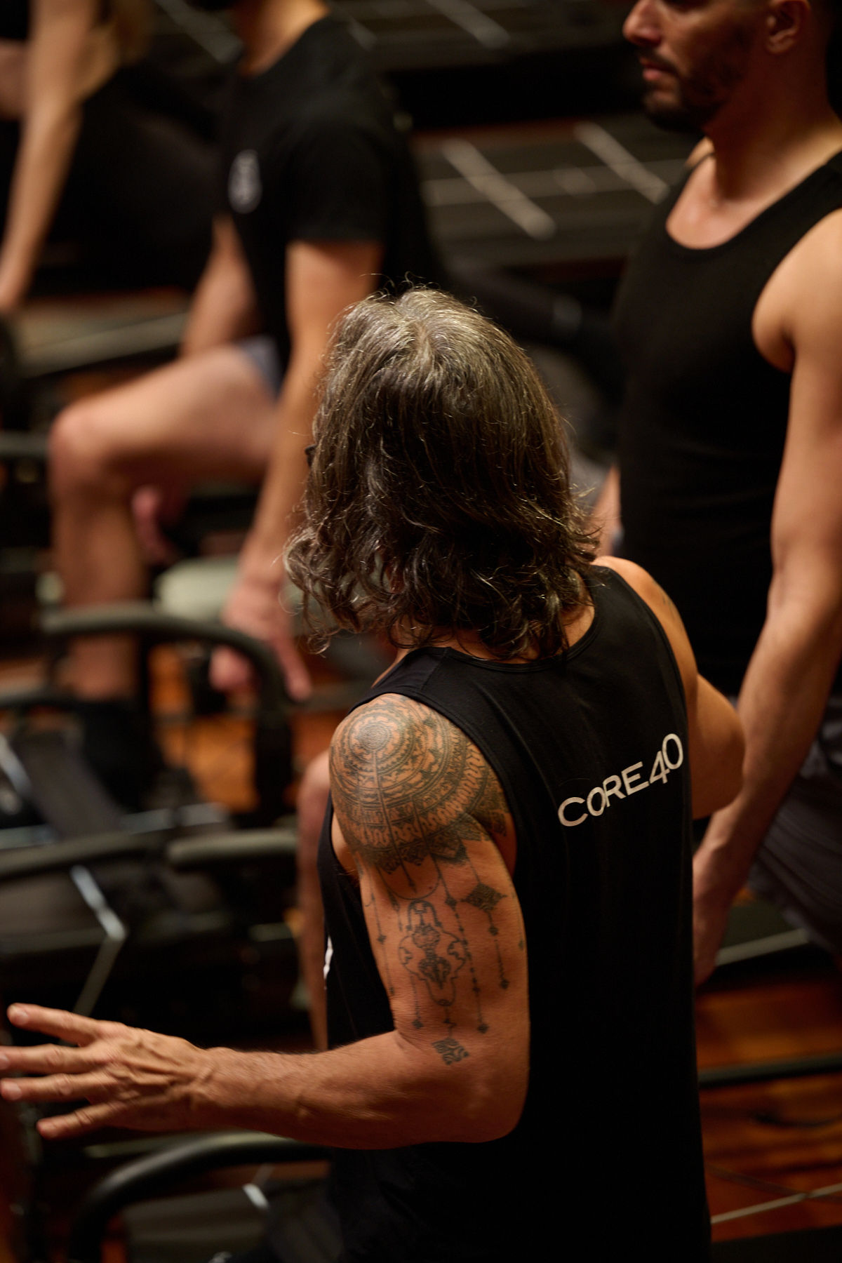 Dean in CORE40 tank coaching the room